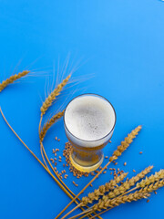 Beer glass on blue table top view.