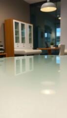 close up of a glass table with a white cabinet in the background