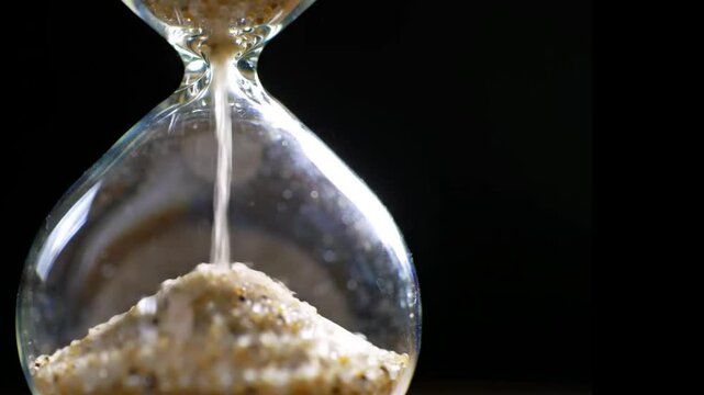Hourglass with copy space on black background.  Generative AI.