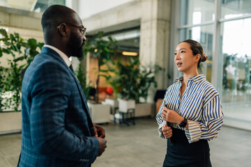 Businesspeople discussing strategy in modern office environment