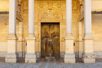 Historic architectural entrance with ornate stone columns and intricate carvings