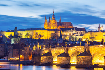 Illuminated St Vitus Cathedral and Charles Bridge at night in Prague Czech Republic