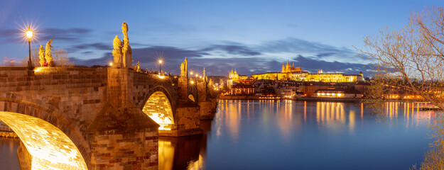 Night view of Charles Bridge with statues and lights in Prague Czech Republic