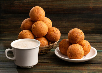 Fried cheese buñuelos accompanied by a hot chocolate drink - Typical Colombian cuisine