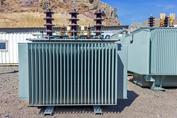 View of big transformer. In electrical engineering, a transformer is a passive component that transfers electrical energy from one electrical circuit to another circuit, or multiple circuits.