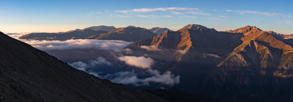 This panorama of the Sawatch Range shows mountains rising above an early morning cloud inversion, captured during a summer hike of 14er Mt Elbert.