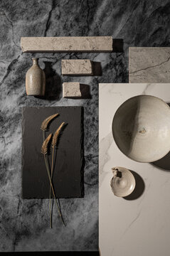 Flatlay with different textures of marble, ceramics and dried grass.