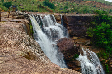 Dainthlen waterfall of Meghalaya, a Majestic waterfall cascading through dense forest, captured in...