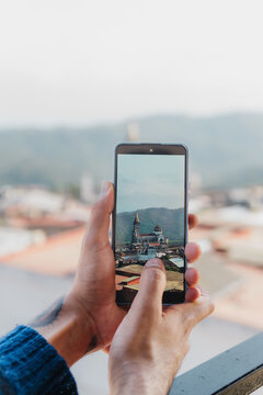 Man's hands taking photo.