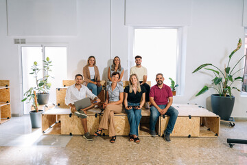Startup team members sitting together in their workspace
