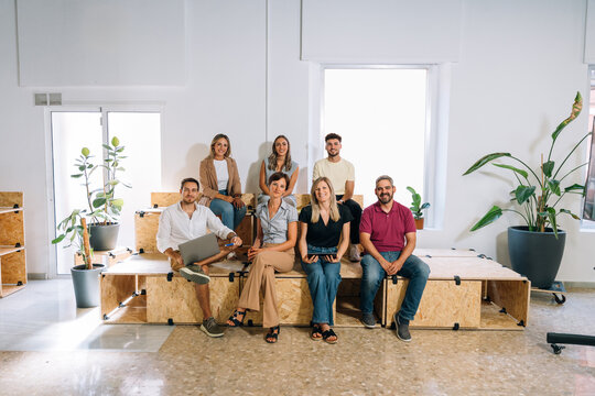 Startup team members sitting together in their workspace