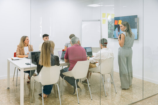 Marketing team analyzing data on laptops during office meeting