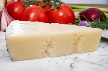 Pieces of matured pecorino romano italian cheese made from sheep milk in Lazio, Sardinia or Tuscany