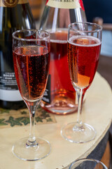 Pouring and tasting of rose or pink cuvee sparkling wine brut, grand reserve, champagne in Ay-Champagne wine making village in Vallee de la Marne, , Champagne region, France