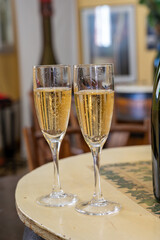 Pouring and tasting of dry sparkling wine brut, grand reserve, champagne in Ay-Champagne wine making village in Vallee de la Marne, , Champagne region, France