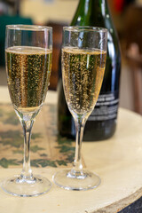 Pouring and tasting of dry sparkling wine brut, grand reserve, champagne in Ay-Champagne wine making village in Vallee de la Marne, , Champagne region, France