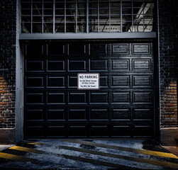 Down town City Garage Door with a no parking sign