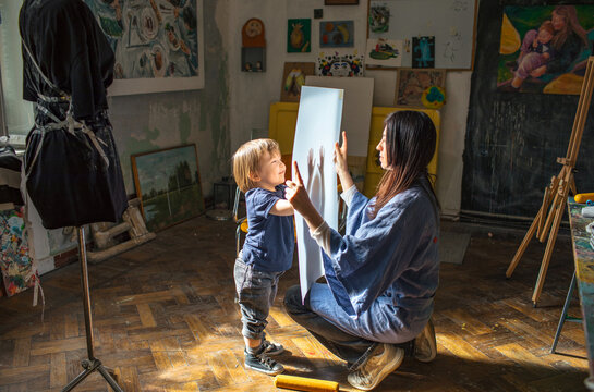 Naklejki  mother plays with her little son in the room