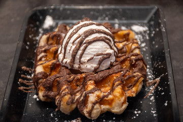 Baked belgian sugar waffles with various toppings, delicious sweet street food in Bruges, Flanders, Belgium