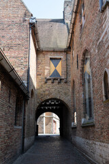 Fototapeta premium Medieval houses facades and rooftops and city tower with bells in the centre of Bruges, Flanders