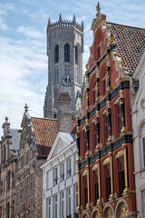 Obraz premium Medieval houses facades and rooftops and city tower with bells in the centre of Bruges, Flanders