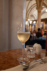 Lifestyle of beautiful Vienna, glass of cold white dry Austrian wine served in old Viennese-style cafe in Vienna, Austria