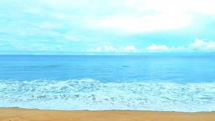 Fototapeta premium The vast tropical sea stretches under a soft blanket of clouds, with gentle waves caressing the sandy shore. A serene and peaceful atmosphere fills the air, perfect for a tranquil getaway. 