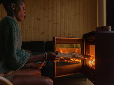 Astonished woman loading fireplace