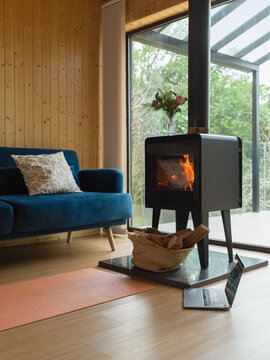 Fire burning in small chiminea at rural wooden house