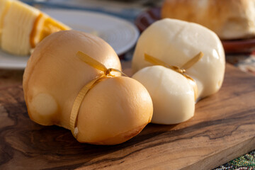 Italian semi hard handmade white and smoked scamorza cheese, from cow milk from Apulia or Calabria...