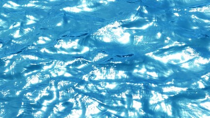 An aerial shot showcases the crystal-clear turquoise water, where sunlight reflects off the ocean’s surface, creating a mesmerizing pattern of light and water in the tropical landscape.
