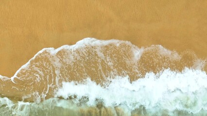 A stunning image of a sea wave crashing onto the shore, the white foam flowing across the sand, embodying the natural energy and fluid motion of the ocean in its most tranquil form.
