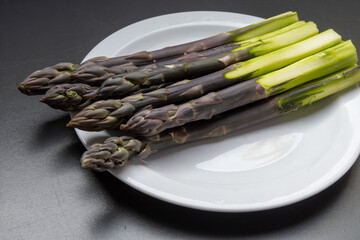 Garden or farm to table concept, fresh organic purple asparagus vegetables, seasonal foood, tasty healthy food
