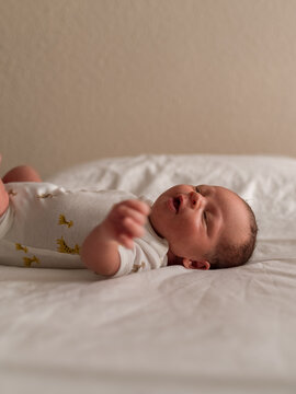 Little newborn lying on bed