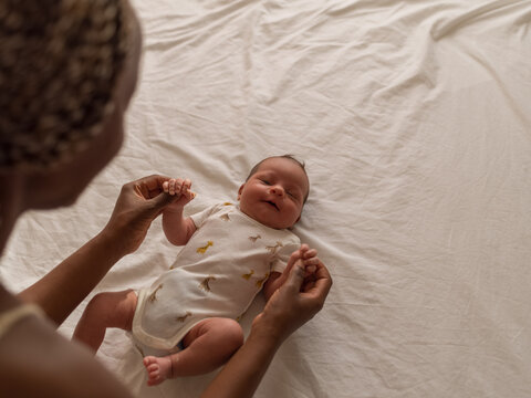 Mother playing with newborn