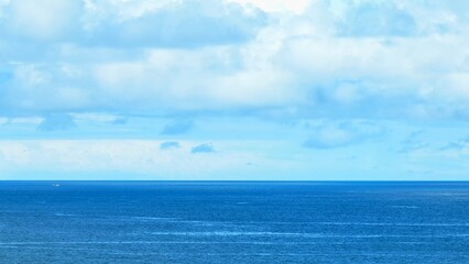 An aerial shot capturing the calming expanse of the ocean, with gentle ripples across the blue waters and a wide, open sky, ideal for peaceful and natural landscape imagery. Phuket, Thailand.

