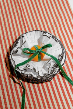 Orange Wrapped in White Fabric