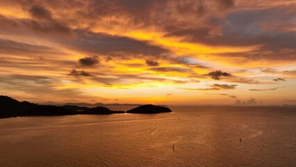A stunning sunset over the ocean, with vibrant orange and purple hues painting the sky as the sun...