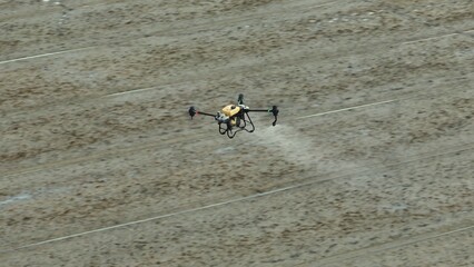 Fototapeta premium A modern agricultural drone sprays pesticides with precision over rice fields, enhancing efficiency, sustainability, and crop health through innovative automated farming technology. 