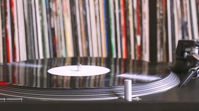 DJ headshell on spinning turntable. Listening the music on vinyl. Closeup