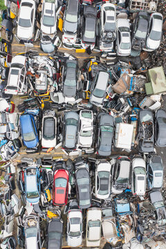 Aerial View of a Busy Scrapyard with Discarded Cars and Metal