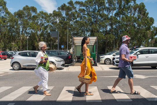 Family walk on zebra crossing in supermarket parking lot