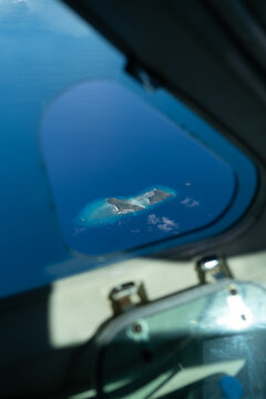 Fototapeta Tiny Island Seen Through Aircraft Window