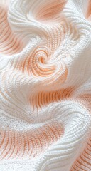 Close-up of textured fabric, swirling patterns in a soft peach and white ombre