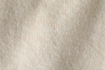 Texture of beige wool fabric as background, top view