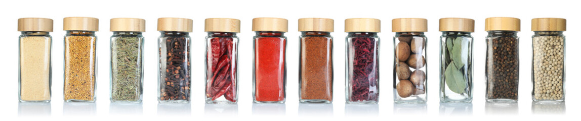 Different spices in glass jars on white background, set