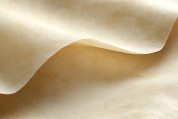 Close-up of pale beige, smooth, pliable sheet