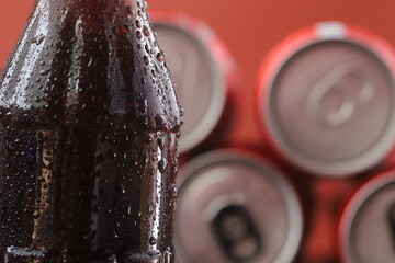 Soft drink bottle with a red background
