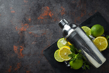 Metal shaker with fresh lime on a dark background