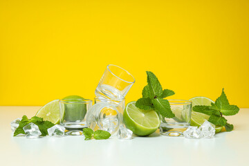 Glasses with fresh lime and ice cubes